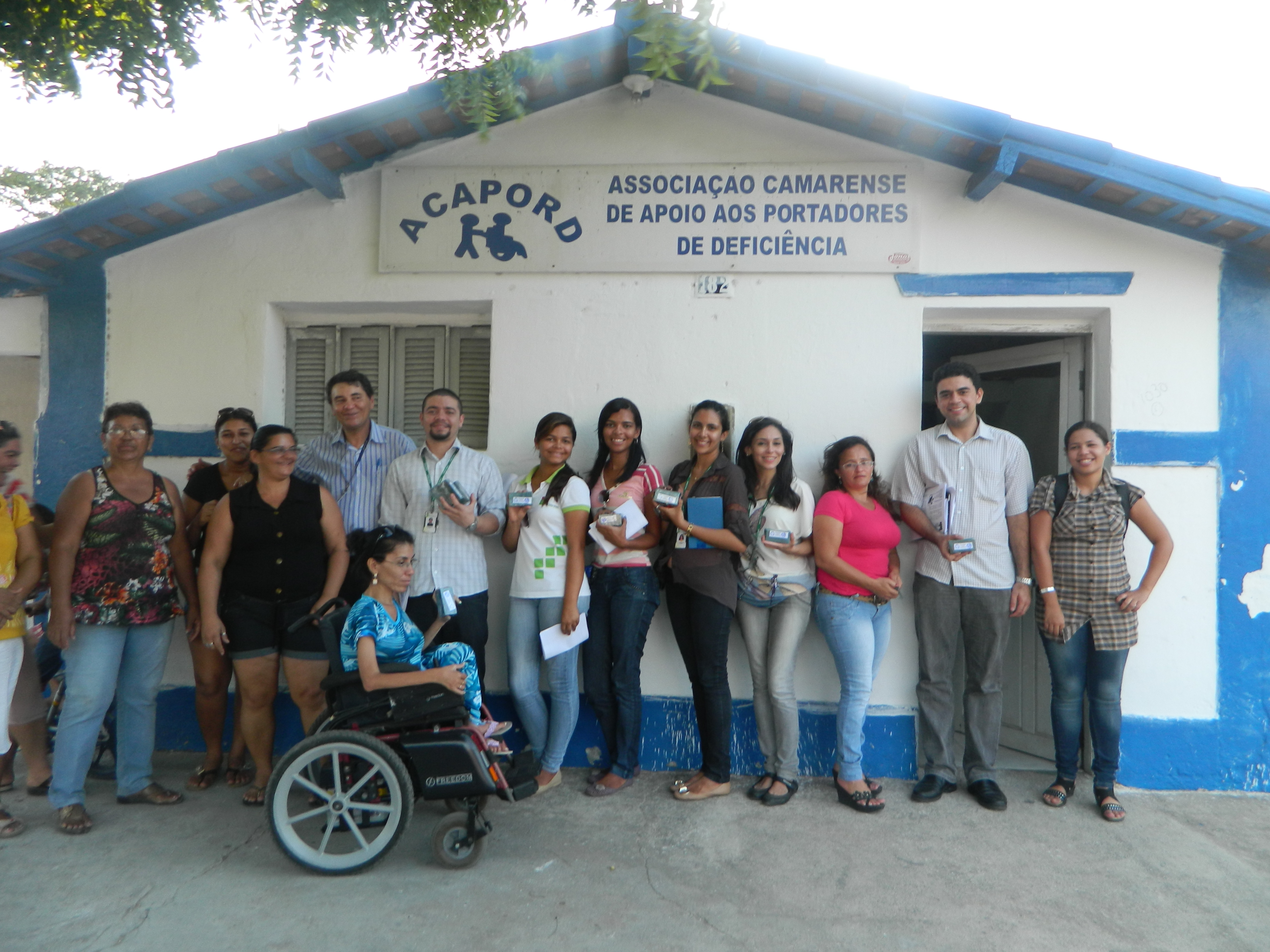 fachada da frente da ACAPORD com parte da equipe